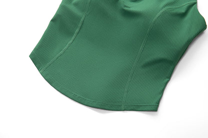 Close-up of the curved hem and contour seams on the green ribbed sleeveless golf top
