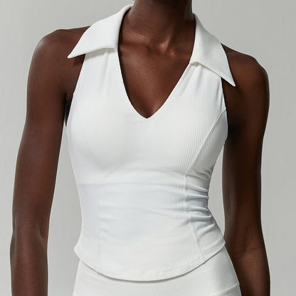 White ribbed sleeveless golf top on a model, front view showing the ribbed knit and curved hem